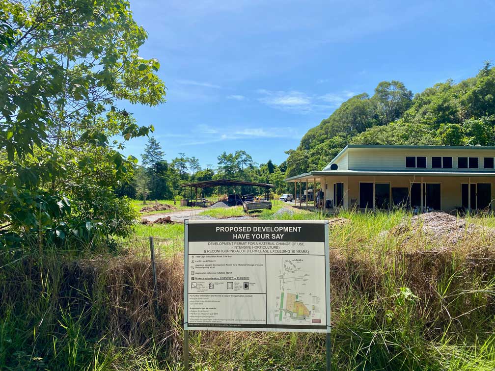 The site for the New Native Nursery - View from front gate showing development application sign, old hangar and house