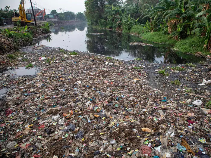 The Pisang Batu River in Indonesia covered in rubbish. Donal Husni/NurPhoto via Getty Images